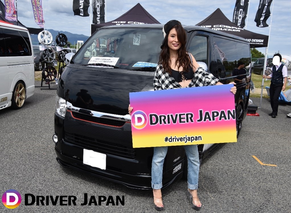 スーパーカーニバル2018参加ブースのハイエースの隣に立つ智花ちゃん